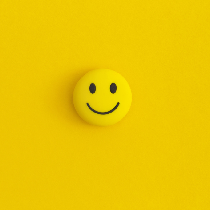 Emoticon smile on a yellow background